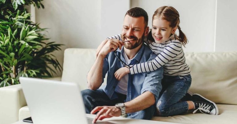 dad working from home with little girl